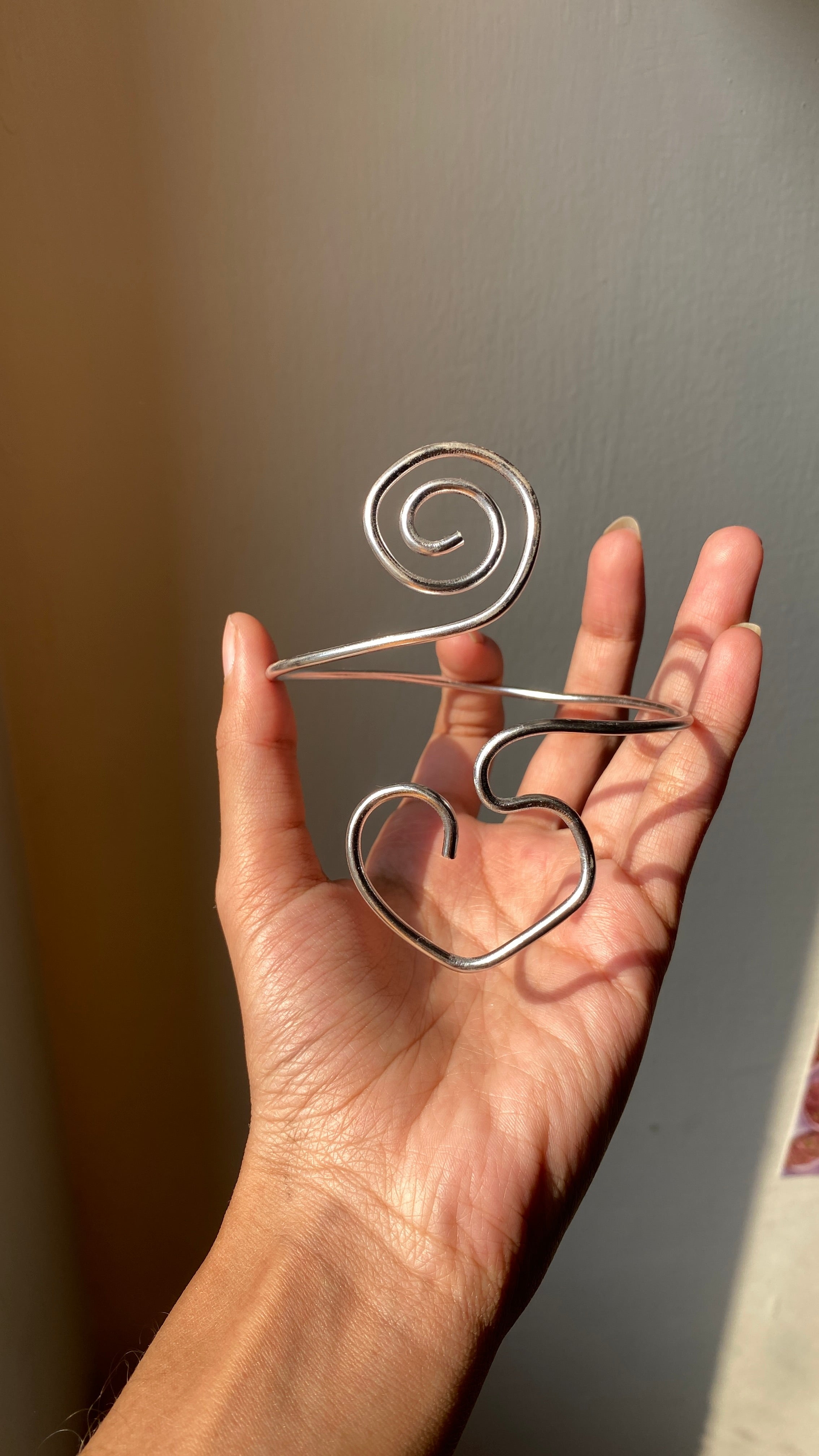 Spiral heart armcuff